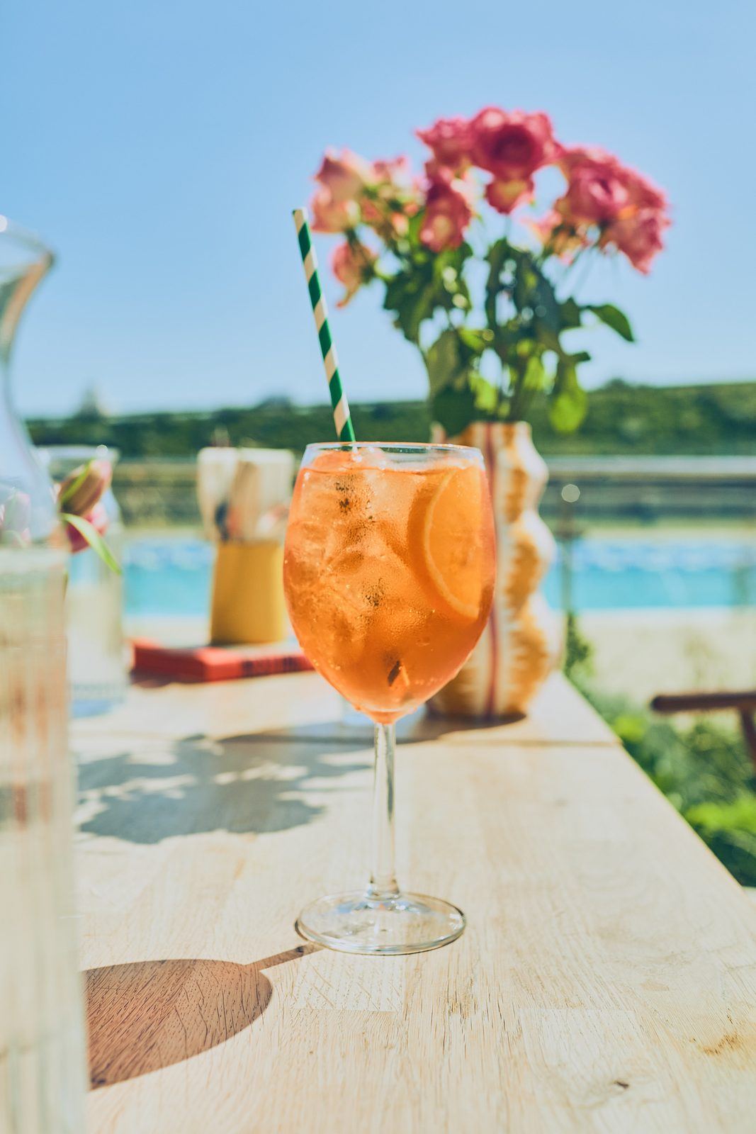Cold glass, warm sun, a long afternoon by the pool